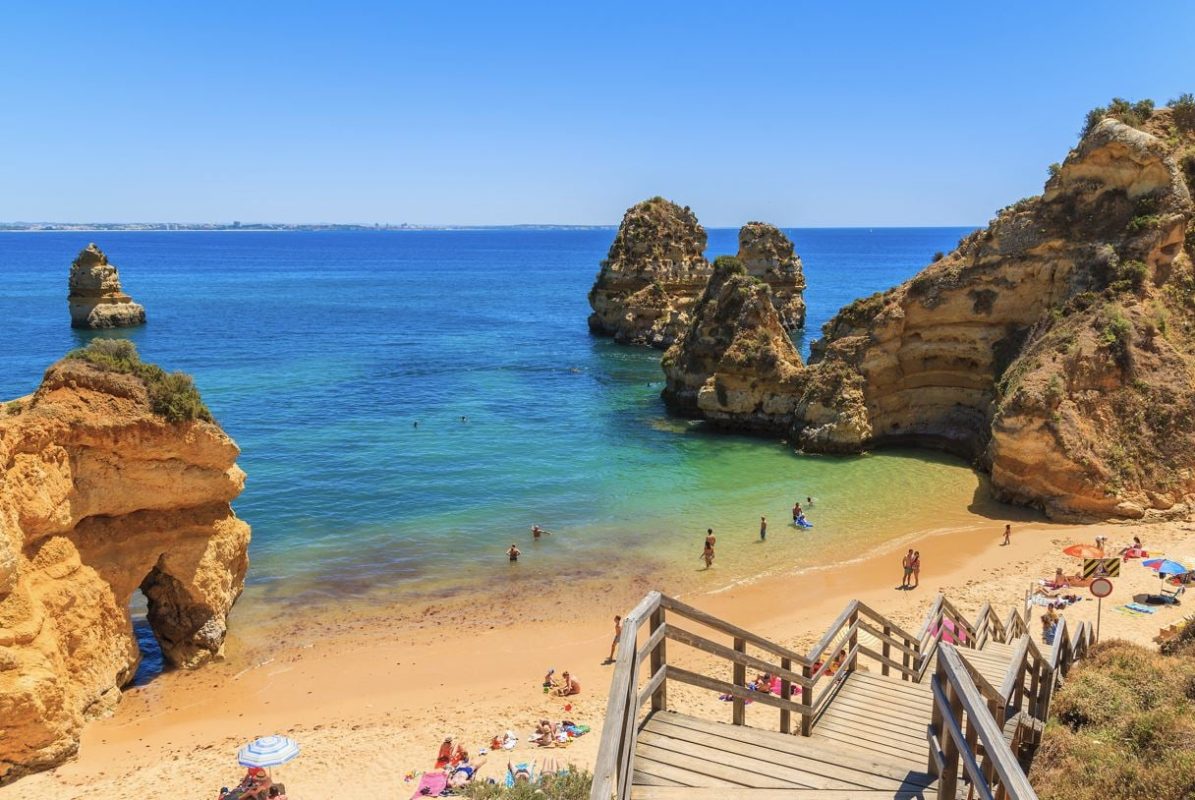 Wooden walkway to the beautiful beach Praia